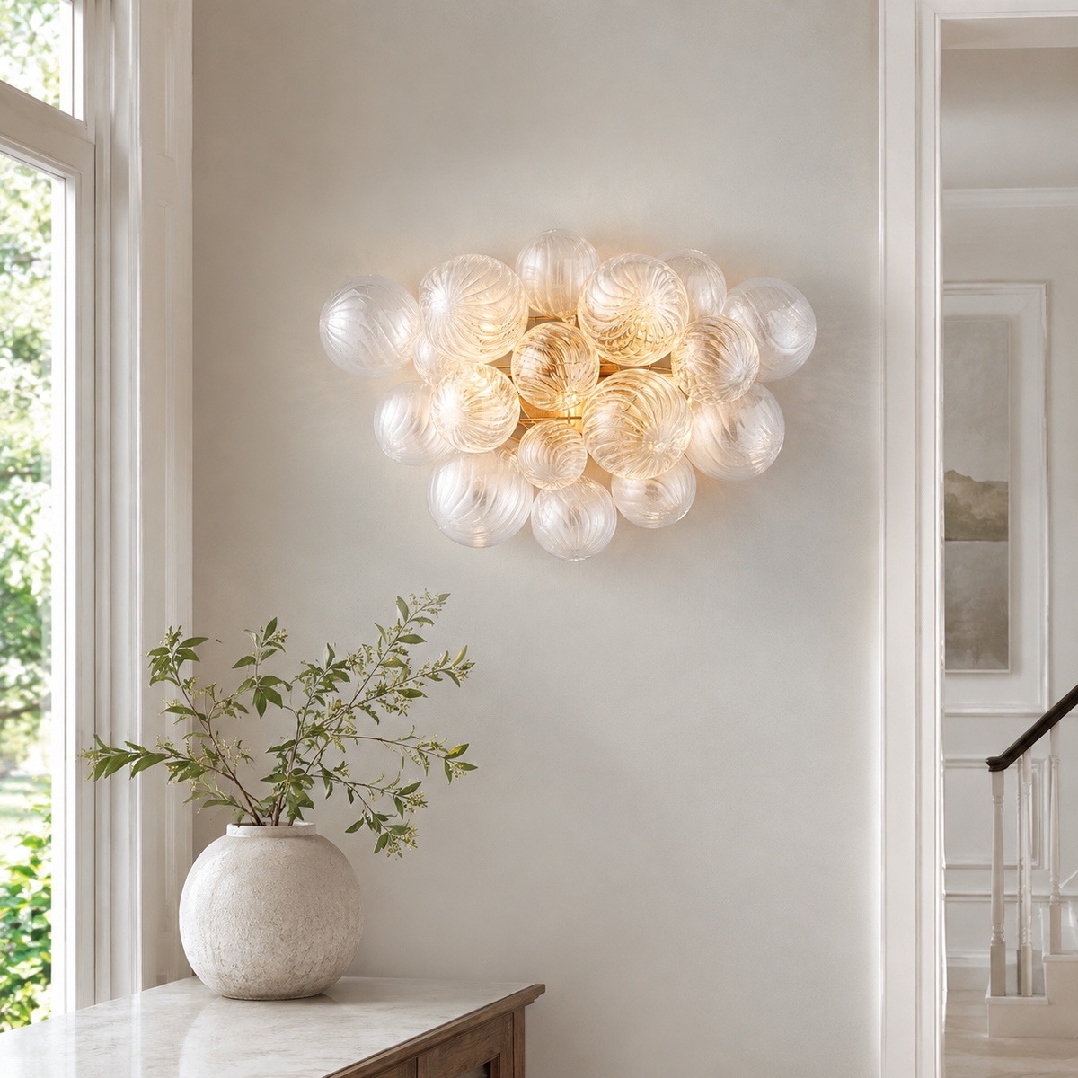 Talia Modern Grand Sconce installed in a bright neutral entryway