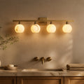Modern Luxury Arica 4-Light Sconce in a warm bathroom interior