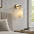 Callista Spanish Marble and Copper Wall Light installed beside a bed