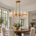 Ravelle 48-inch brass milk-glass chandelier above a round dining table in a sunlit American villa