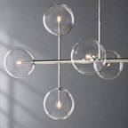Sierra 72-inch polished nickel linear chandelier glass globe and metalwork detail on a textured gray background