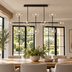 Sierra black linear globe chandelier over a dining table
