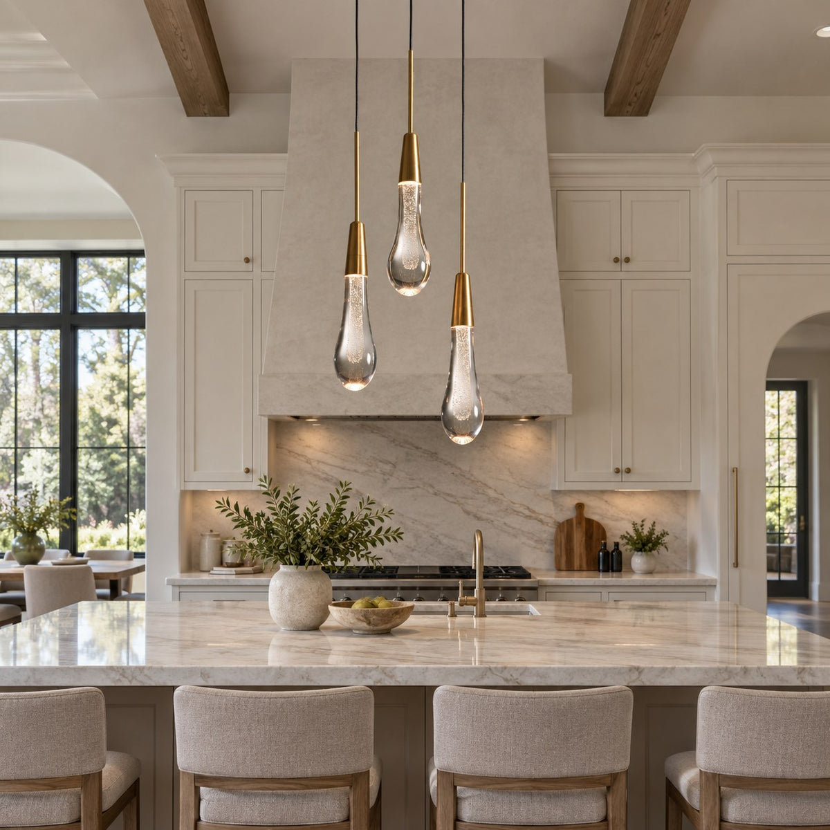 Solitaire three-light crystal pendant above a villa kitchen island