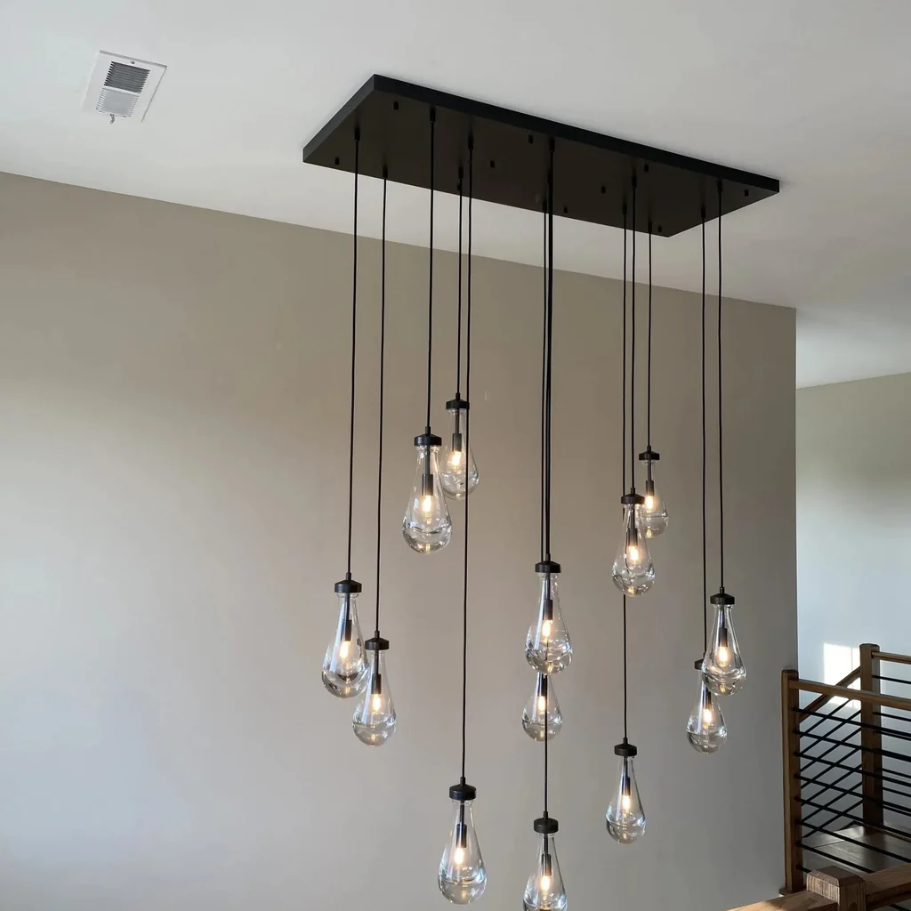 Customer installation of a multi-light glass pendant in a stairwell