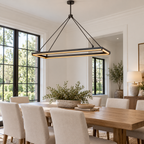 Peral iron rectangular chandelier above a dining table in a daylight-filled home