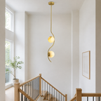 Uva Curved Alabaster Pendant Light installed over a bright stair landing